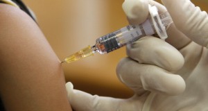 A doctor vaccinates a patient in a municipal vaccination centre in Nice
